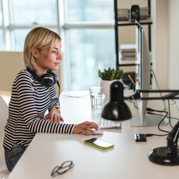 Woman working on a laptop in an office